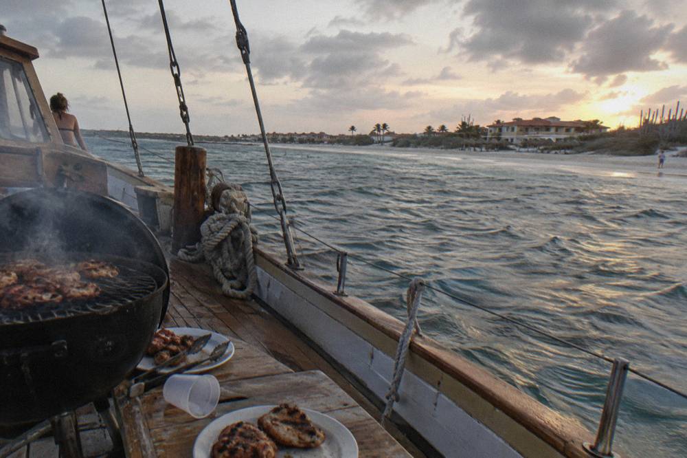 Barbecue grill and deck of a wooden schooner set for an evening dinner cruise