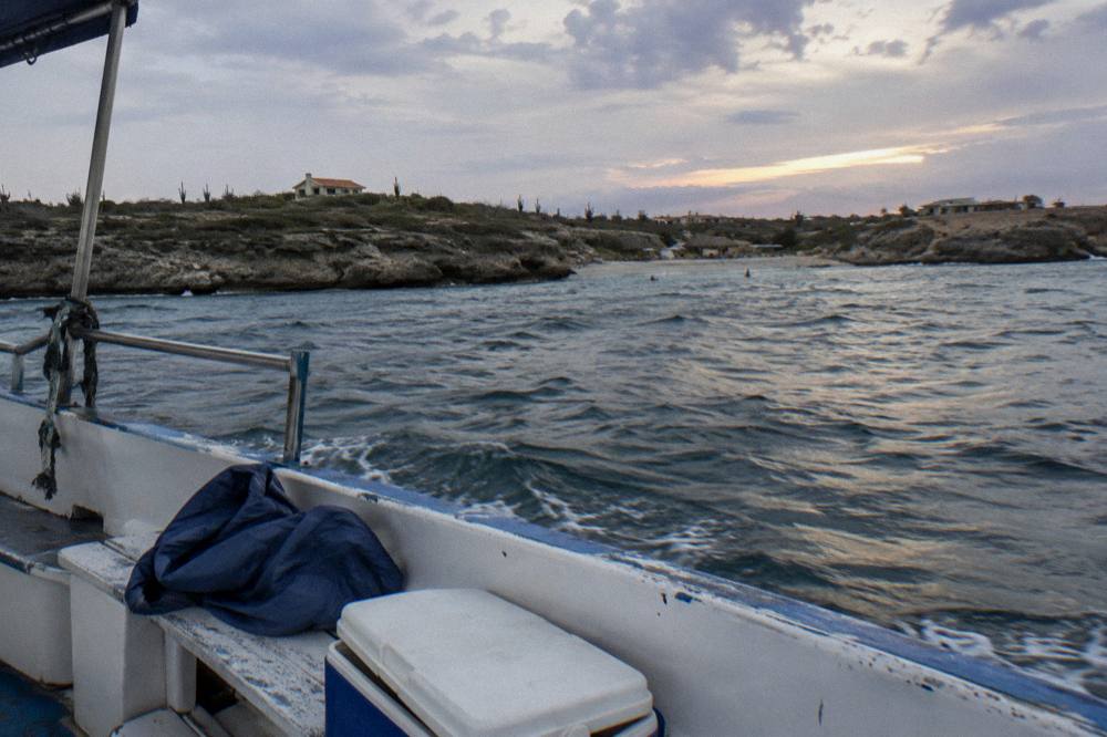 Calm evening sea and darkening sky over the Caribbean horizon seen from a boat deck