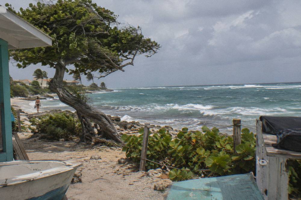 Clouds gathering over the Caribbean horizon with whitecaps on open water beyond a sheltered reef line