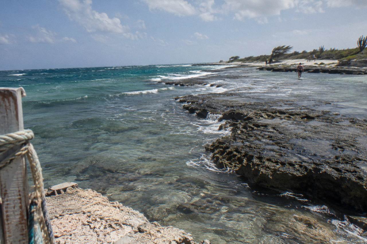 Clear shallow water over a rocky reef ledge on the northwest coast of Aruba