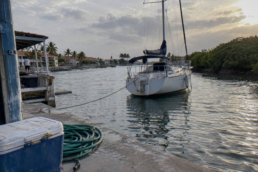 Private sailing boat at anchor near an Oranjestad marina before sunset